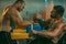 The Armwrestling. Two strong athletes in the gym compete in arm wrestling. Bodybuilders armwreslers in athletic training