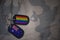 army blank, dog tag with flag of australia and gay rainbow flag on the khaki texture background.