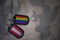 army blank, dog tag with flag of austria and gay rainbow flag on the khaki texture background.