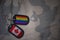 army blank, dog tag with flag of canada and gay rainbow flag on the khaki texture background.