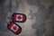 Army blank, dog tag with flag of canada on the khaki texture background.