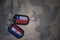 army blank, dog tag with flag of chile and paraguay on the khaki texture background.