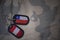 army blank, dog tag with flag of chile and peru on the khaki texture background.