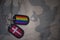 army blank, dog tag with flag of denmark and gay rainbow flag on the khaki texture background.