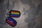 army blank, dog tag with flag of haiti and gay rainbow flag on the khaki texture background.