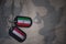 army blank, dog tag with flag of iran and yemen on the khaki texture background.