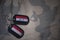 army blank, dog tag with flag of iraq and yemen on the khaki texture background.