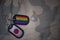 army blank, dog tag with flag of japan and gay rainbow flag on the khaki texture background.