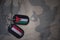 army blank, dog tag with flag of jordan and yemen on the khaki texture background.