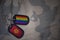 army blank, dog tag with flag of kyrgyzstan and gay rainbow flag on the khaki texture background.