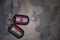 army blank, dog tag with flag of lebanon and kurdistan on the khaki texture background.