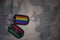 army blank, dog tag with flag of libya and gay rainbow flag on the khaki texture background.