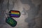 army blank, dog tag with flag of mauritania and gay rainbow flag on the khaki texture background.