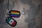 army blank, dog tag with flag of mexico and gay rainbow flag on the khaki texture background.