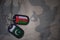 army blank, dog tag with flag of oman and pakistan on the khaki texture background.