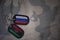 army blank, dog tag with flag of russia and libya on the khaki texture background.