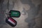 army blank, dog tag with flag of saudi arabia and yemen on the khaki texture background.