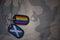 army blank, dog tag with flag of scotland and gay rainbow flag on the khaki texture background.