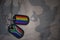 army blank, dog tag with flag of south africa and gay rainbow flag on the khaki texture background.