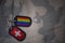 army blank, dog tag with flag of switzerland and gay rainbow flag on the khaki texture background.