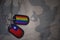army blank, dog tag with flag of taiwan and gay rainbow flag on the khaki texture background.