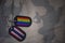 army blank, dog tag with flag of thailand and gay rainbow flag on the khaki texture background.