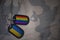 army blank, dog tag with flag of ukraine and gay rainbow flag on the khaki texture background.