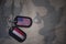 army blank, dog tag with flag of united states of america and yemen on the khaki texture background.