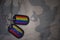 army blank, dog tag with flag of venezuela and gay rainbow flag on the khaki texture background.