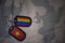 army blank, dog tag with flag of vietnam and gay rainbow flag on the khaki texture background.