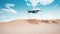 Army cargo aircraft flying low over sandy desert 4K
