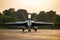 Army fighter airplane with open cockpit. Military navy pilot waving after landing in beautiful sunset light