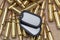 Army identification tokens lie on scattered yellow machine gun cartridges, selective focusing. Concept: military special operation