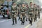 The army people in the uniform with the bofors canon on the backdrop