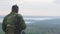 Army soldier with Sniper rifle in action in mountains. Back view