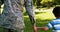 Army soldier walking with boy in park