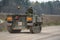 army tracked personnel carrier driving an unmade road