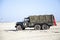 Army trucks of organization Kelly\'s Heroes riding on beach