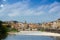 The Arno river and the cloudy Florence. Rainy weather with dark blue clouds hanging over the Italian city - Florence