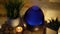 Aroma electric oil diffuser lamp, candles on wooden table in room. Aromatherapy, 4k