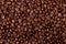 Aroma roasted coffee beans, brown banner background. Soft focus close up