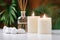 Aromatherapy Concept. Aromatic White Candles and Essential Oil Reed Diffusers