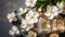 Aromatherapy concept, Top view of glass bottles of geranium essential oil with fresh white flowers and petals on table