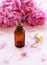 Aromatherapy essentials oils and pink peonies