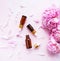 Aromatherapy essentials oils and pink peonies