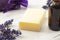 Aromatherapy spa and natural hygiene products concept with homemade soap surrounded by violet pouch of dried lavender, purple