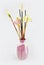 Aromatherapy sticks and decorative artificial flowers in pink ceramic vase