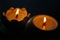 An aromatic candle burns in the dark and creates a romantic atmosphere. The fire is burning. A romantic candlelit dinner