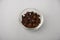 Aromatic cloves on white glass bowl with white background.