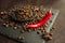 Aromatic coffee beans in a metal Turkish bowl, anise with bitter hot chili pepper on a black background 1